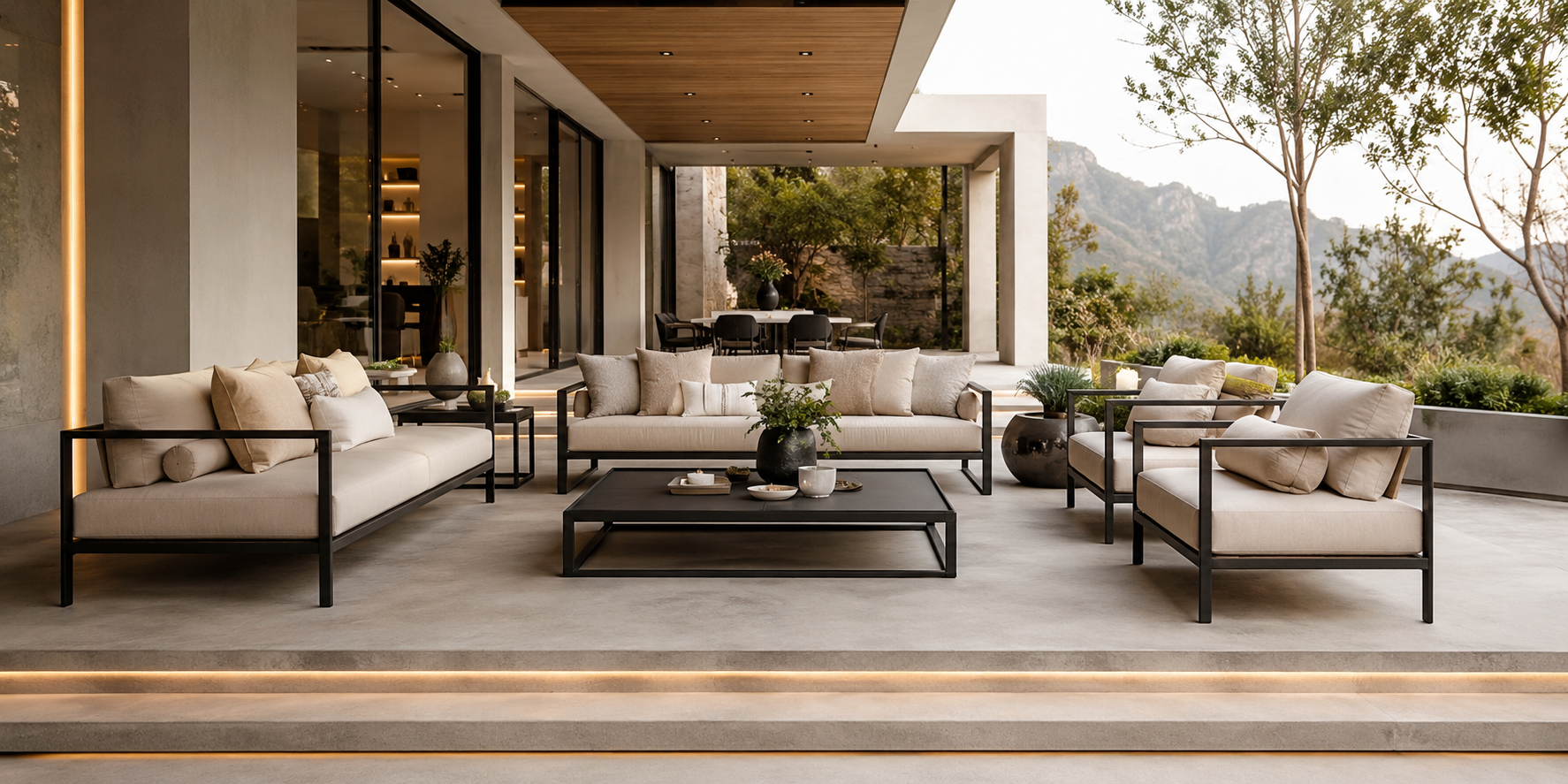 A modern minimalist porch with a sleek concrete floor, black-framed furniture, neutral cushions, and linear LED lighting