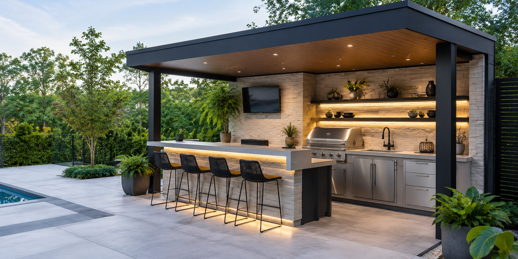 Small covered outdoor kitchen with dual-height counter, bar stools, and under-counter lighting.