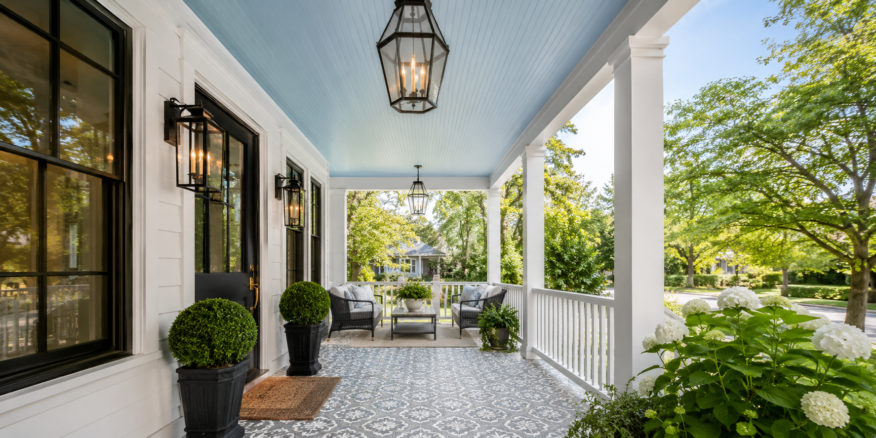 Porch with sky-blue beadboard ceiling and patterned gray-white floor tiles.
