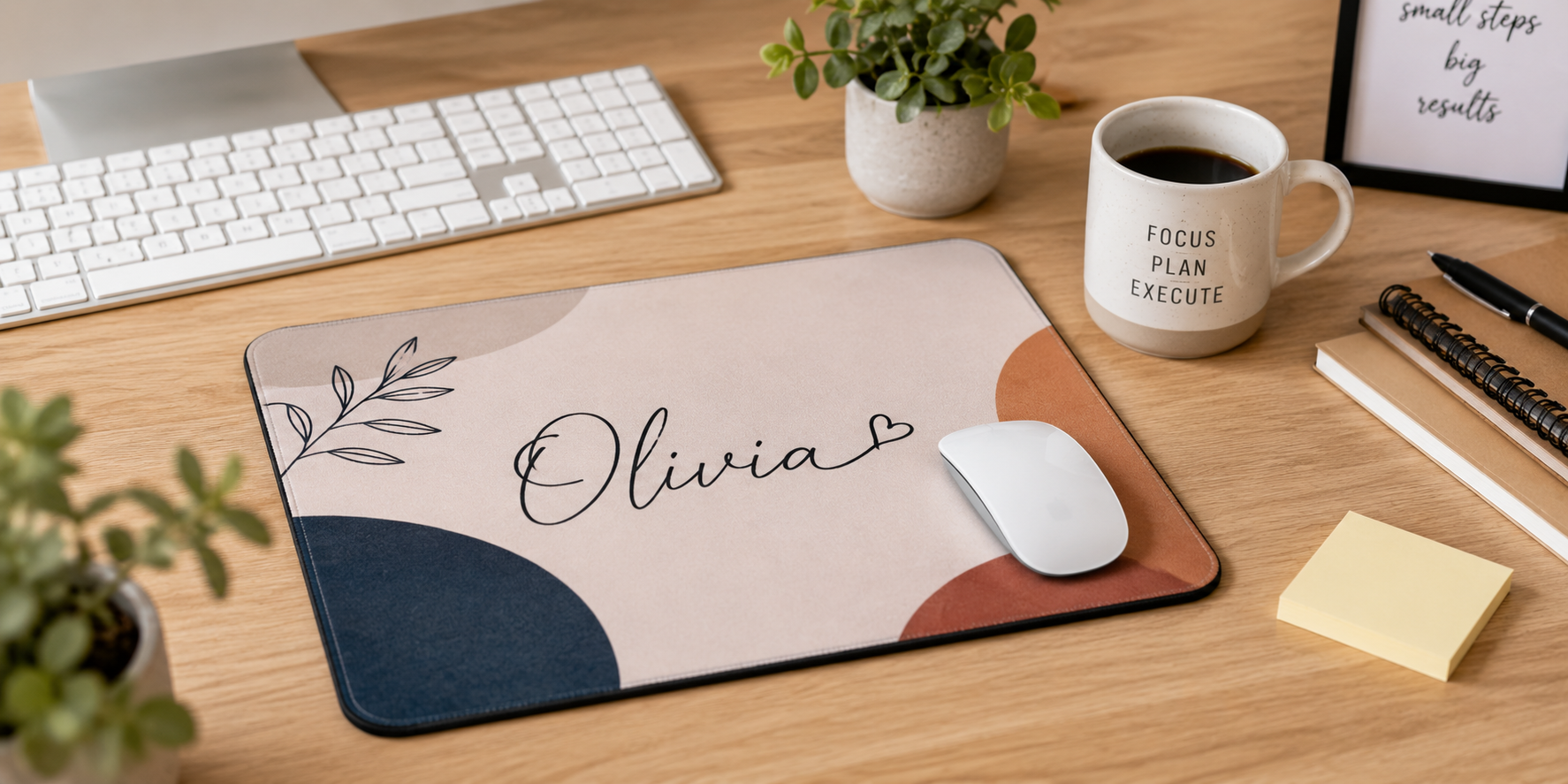 A custom mouse pad with name printing, placed on an office desk beside a keyboard and coffee mug