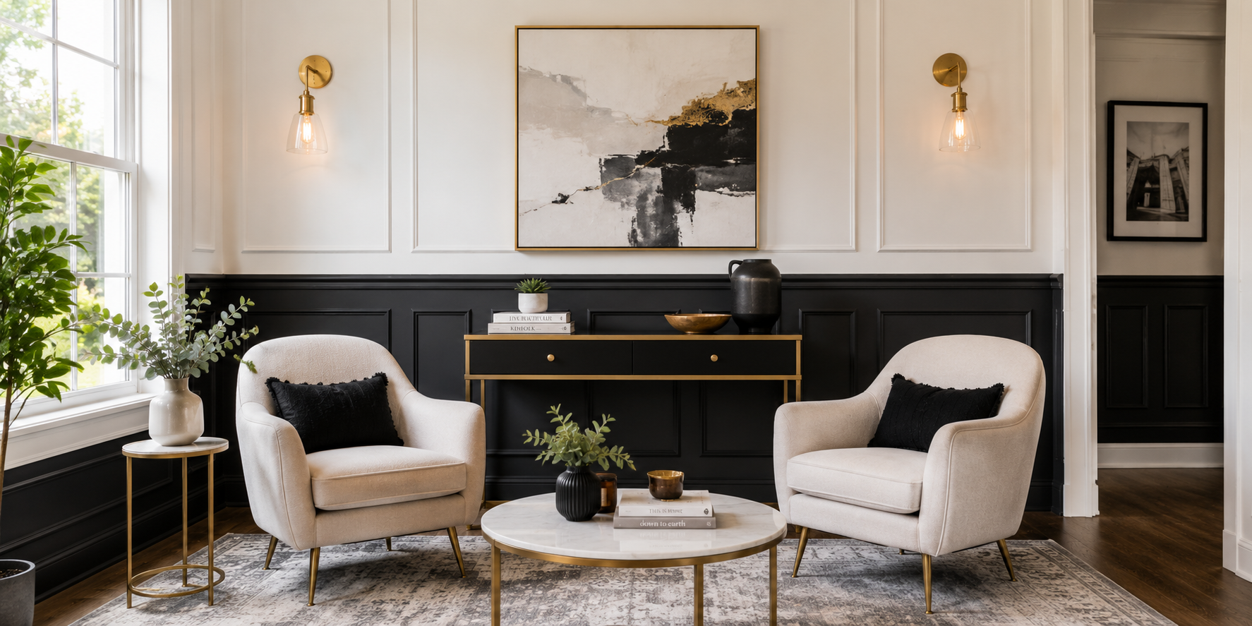 Modern sitting area featuring two-tone shaker wall panels — charcoal lower panels and white upper walls. Accented by brass fixtures and contemporary artwork.